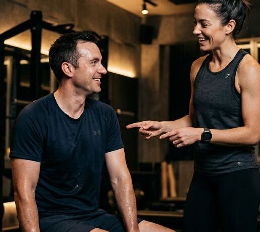 Trainer coaching client during adaptive resistance strength workout