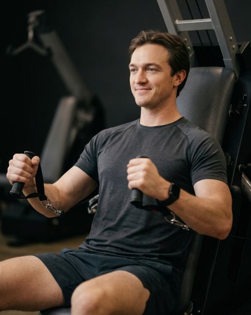 Man performing chest press on adaptive resistance machine